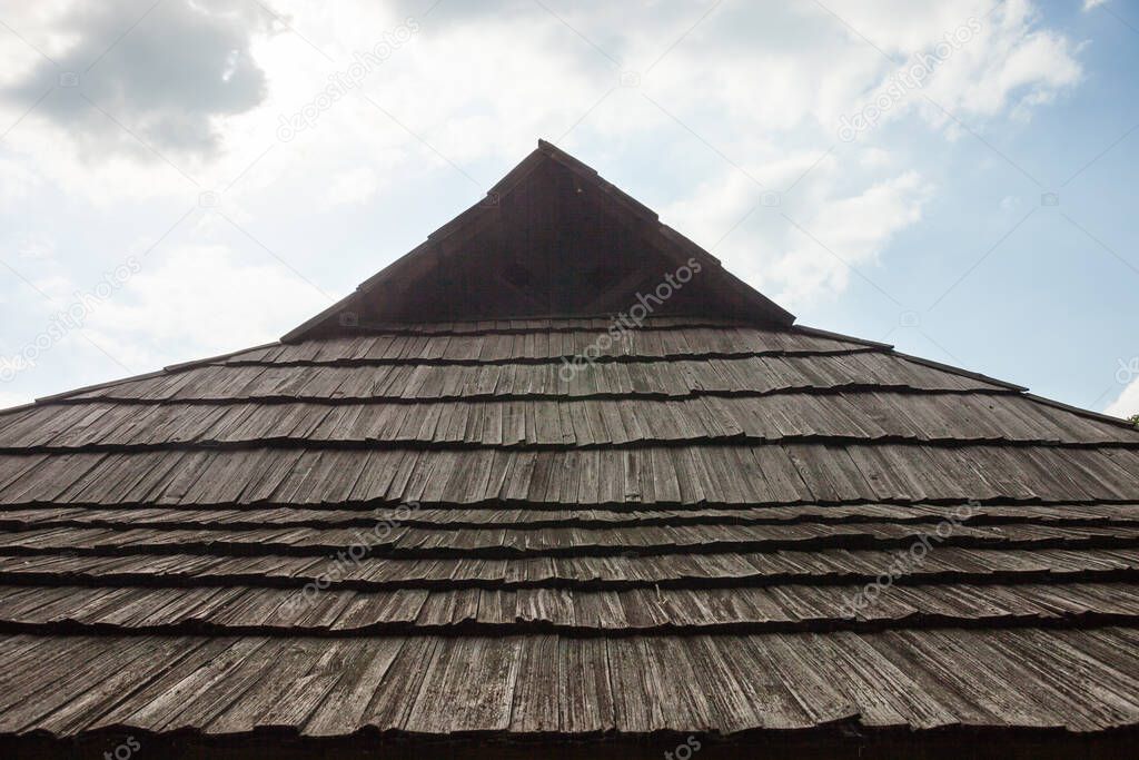 Old wooden shingle roof against the sky. Old traditional Ukrainian architecture. 