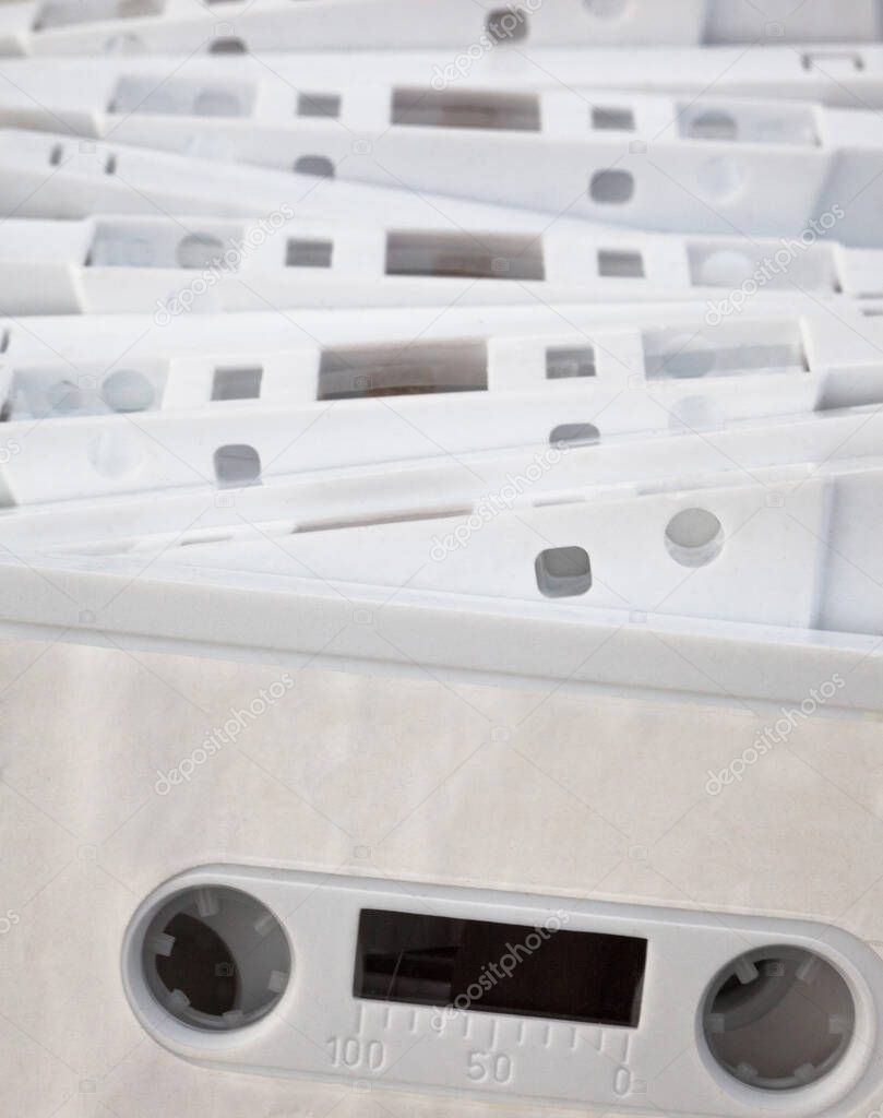 White cassette tapes (compact cassettes or musicassettes, MC). Analog magnetic tape recording format for audio recording and playback.