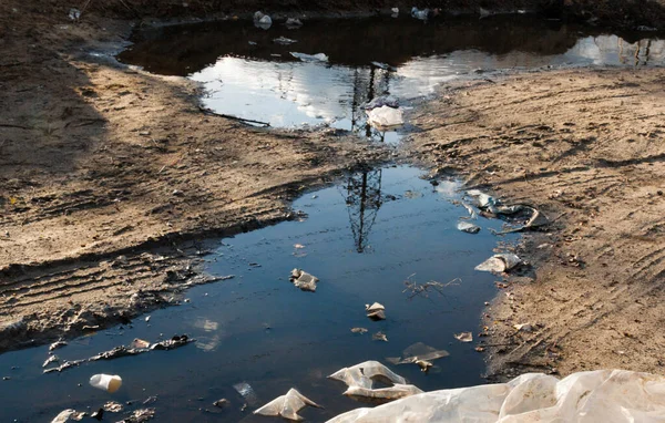 泥泞中的垃圾 泥泞路上的水坑 环境污染 — 图库照片