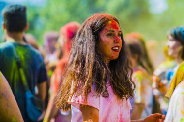 Montreal, Canada - August 10, 2019: People celebrate HOLI Festival throwing color powders in Horloge Park in Montreal