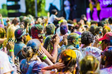 Montreal, Canada - August 10, 2019: People celebrate HOLI Festival throwing color powders in Horloge Park in Montreal