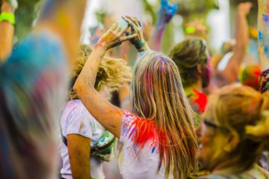 Montreal, Canada - August 10, 2019: People celebrate HOLI Festival throwing color powders in Horloge Park in Montreal