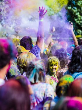 Montreal, Canada - August 10, 2019: People celebrate HOLI Festival throwing color powders in Horloge Park in Montreal
