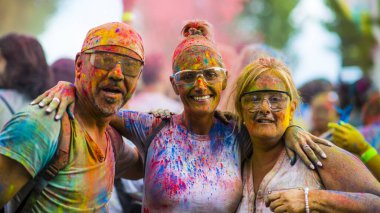 Montreal, Canada - August 10, 2019: People celebrate HOLI Festival throwing color powders in Horloge Park in Montreal