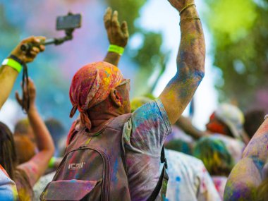 Montreal, Canada - August 10, 2019: People celebrate HOLI Festival throwing color powders in Horloge Park in Montreal