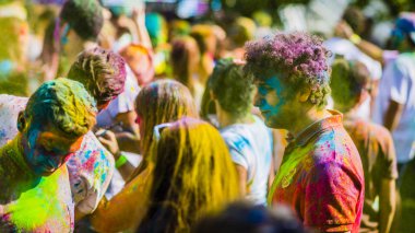 Montreal, Canada - August 10, 2019: People celebrate HOLI Festival throwing color powders in Horloge Park in Montreal