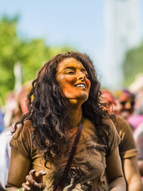 Montreal, Canada - August 10, 2019: People celebrate HOLI Festival throwing color powders in Horloge Park in Montreal
