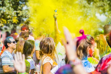 Montreal, Canada - August 10, 2019: People celebrate HOLI Festival throwing color powders in Horloge Park in Montreal