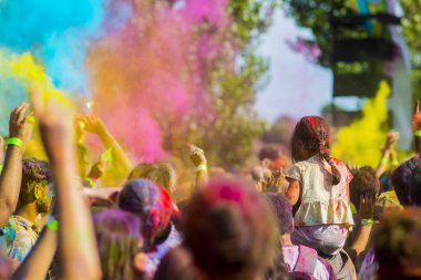 Montreal, Canada - August 10, 2019: People celebrate HOLI Festival throwing color powders in Horloge Park in Montreal