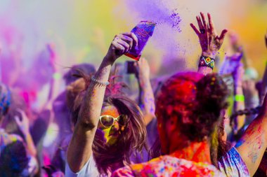 Montreal, Canada - August 10, 2019: People celebrate HOLI Festival throwing color powders in Horloge Park in Montreal
