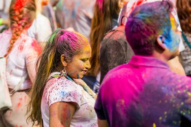 Montreal, Canada - August 10, 2019: People celebrate HOLI Festival throwing color powders in Horloge Park in Montreal