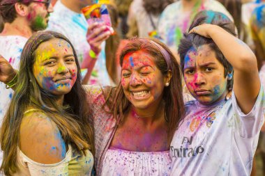 Montreal, Canada - August 10, 2019: People celebrate HOLI Festival throwing color powders in Horloge Park in Montreal