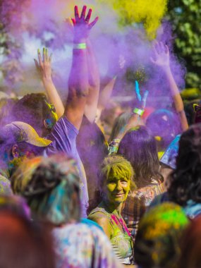 Montreal, Canada - August 10, 2019: People celebrate HOLI Festival throwing color powders in Horloge Park in Montreal