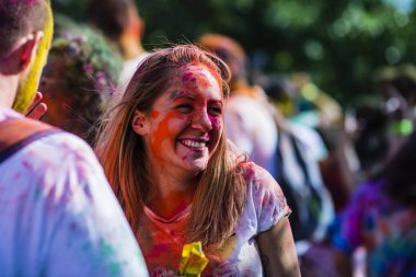 Montreal, Canada - August 10, 2019: People celebrate HOLI Festival throwing color powders in Horloge Park in Montreal
