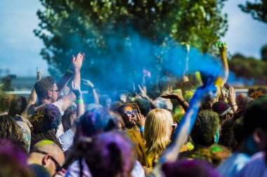 Montreal, Canada - August 10, 2019: People celebrate HOLI Festival throwing color powders in Horloge Park in Montreal