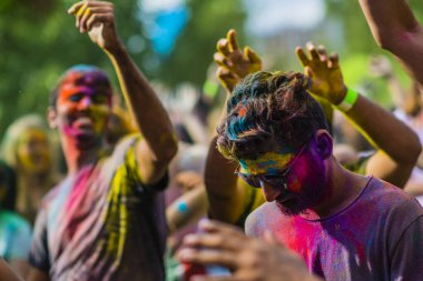 Montreal, Canada - August 10, 2019: People celebrate HOLI Festival throwing color powders in Horloge Park in Montreal