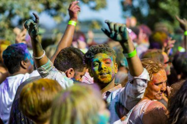 Montreal, Canada - August 10, 2019: People celebrate HOLI Festival throwing color powders in Horloge Park in Montreal