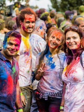 Montreal, Canada - August 10, 2019: People celebrate HOLI Festival throwing color powders in Horloge Park in Montreal