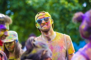 Montreal, Canada - August 10, 2019: People celebrate HOLI Festival throwing color powders in Horloge Park in Montreal