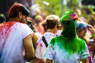 Montreal, Canada - August 10, 2019: People celebrate HOLI Festival throwing color powders in Horloge Park in Montreal