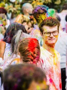 Montreal, Canada - August 10, 2019: People celebrate HOLI Festival throwing color powders in Horloge Park in Montreal