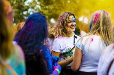 Montreal, Canada - August 10, 2019: People celebrate HOLI Festival throwing color powders in Horloge Park in Montreal