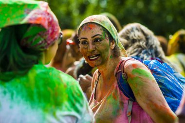Montreal, Canada - August 10, 2019: People celebrate HOLI Festival throwing color powders in Horloge Park in Montreal