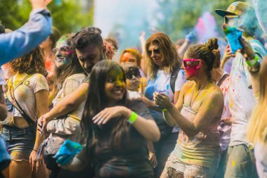 Montreal, Canada - August 10, 2019: People celebrate HOLI Festival throwing color powders in Horloge Park in Montreal