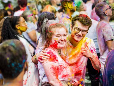 Montreal, Canada - August 10, 2019: People celebrate HOLI Festival throwing color powders in Horloge Park in Montreal