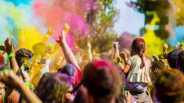 Montreal, Canada - August 10, 2019: People celebrate HOLI Festival throwing color powders in Horloge Park in Montreal