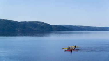 Saint-Rose-du-Nord, Canada - August 14, 2019: People kayaking in Petit Saguenay valley view from Sainte-Rose-du-Nord