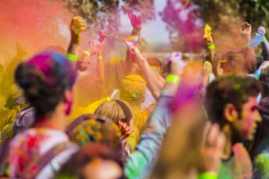Montreal, Canada - August 10, 2019: People celebrate HOLI Festival throwing color powders in Horloge Park in Montreal