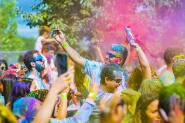 Montreal, Canada - August 10, 2019: People celebrate HOLI Festival throwing color powders in Horloge Park in Montreal