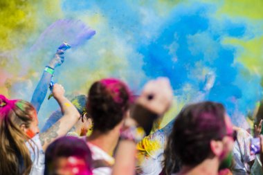 Montreal, Canada - August 10, 2019: People celebrate HOLI Festival throwing color powders in Horloge Park in Montreal