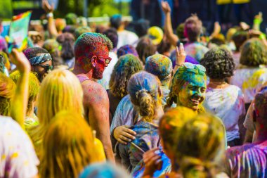 Montreal, Canada - August 10, 2019: People celebrate HOLI Festival throwing color powders in Horloge Park in Montreal