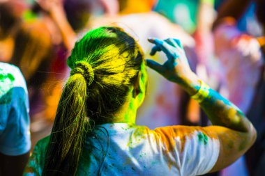 Montreal, Canada - August 10, 2019: People celebrate HOLI Festival throwing color powders in Horloge Park in Montreal