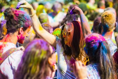 Montreal, Canada - August 10, 2019: People celebrate HOLI Festival throwing color powders in Horloge Park in Montreal