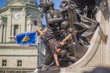 Quebec City, Canada - August 20, 2019: The acrobat show in front of the Angle sculpture in downtown Quebec City