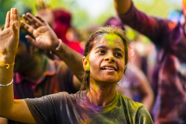 Montreal, Canada - August 10, 2019: People celebrate HOLI Festival throwing color powders in Horloge Park in Montreal