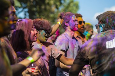 Montreal, Canada - August 10, 2019: People celebrate HOLI Festival throwing color powders in Horloge Park in Montreal