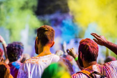 Montreal, Canada - August 10, 2019: People celebrate HOLI Festival throwing color powders in Horloge Park in Montreal
