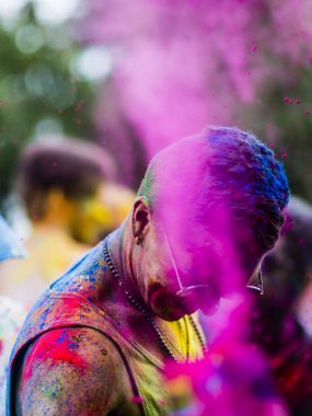 Montreal, Canada - August 10, 2019: People celebrate HOLI Festival throwing color powders in Horloge Park in Montreal