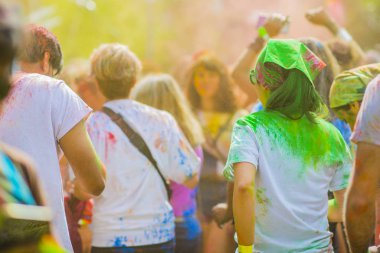 Montreal, Canada - August 10, 2019: People celebrate HOLI Festival throwing color powders in Horloge Park in Montreal