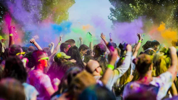 Montreal, Canada - August 10, 2019: People celebrate HOLI Festival throwing color powders in Horloge Park in Montreal