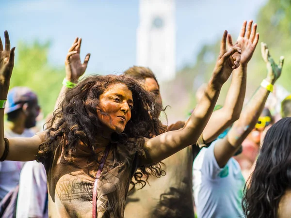 Montreal, Canada - August 10, 2019: People celebrate HOLI Festival throwing color powders in Horloge Park in Montreal