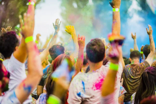 Montreal, Canada - August 10, 2019: People celebrate HOLI Festival throwing color powders in Horloge Park in Montreal