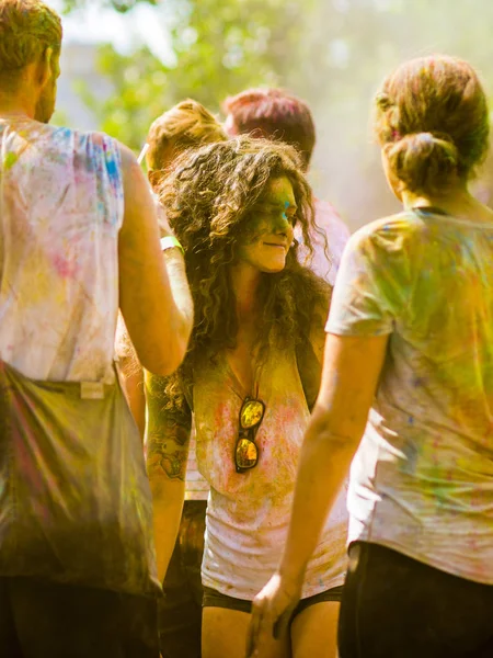 Montreal, Canada - August 10, 2019: People celebrate HOLI Festival throwing color powders in Horloge Park in Montreal