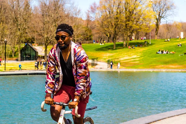 Montreal, Canada - May 12, 2019: Cyclist by the lake of castor in Mont-Royal of Montreal
