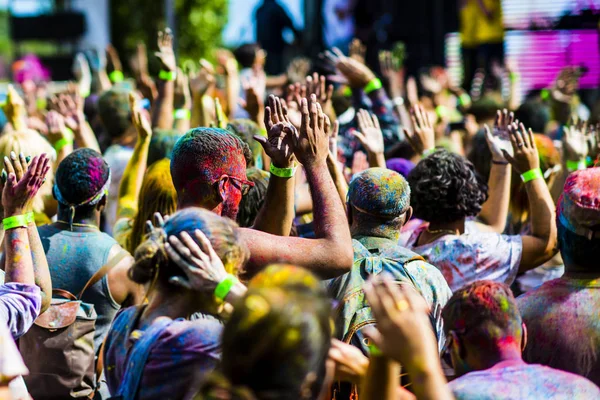 Montreal, Canada - August 10, 2019: People celebrate HOLI Festival throwing color powders in Horloge Park in Montreal