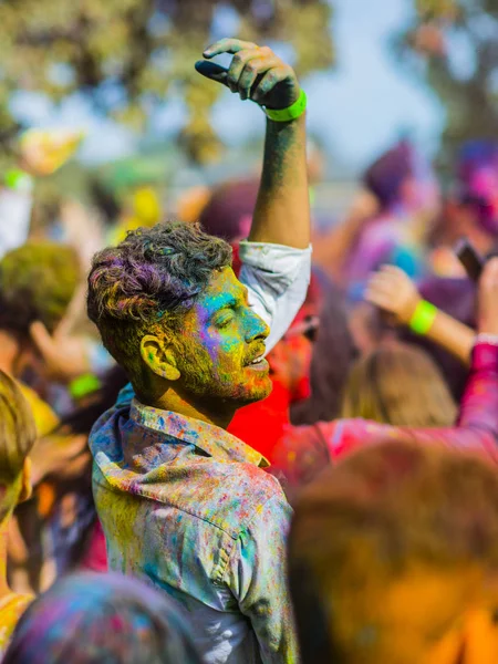 Montreal, Canada - August 10, 2019: People celebrate HOLI Festival throwing color powders in Horloge Park in Montreal